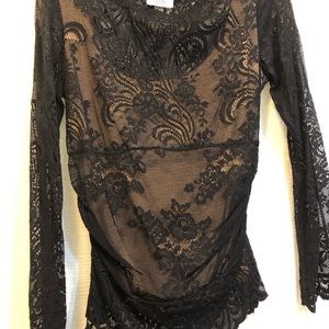 Beautiful black lace detail top. Sheer sleeves, lined torso. Dress up or down.